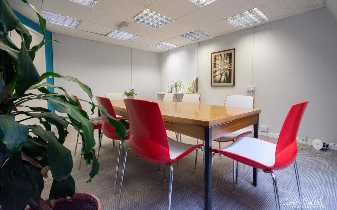 Conference table with red and white chairs